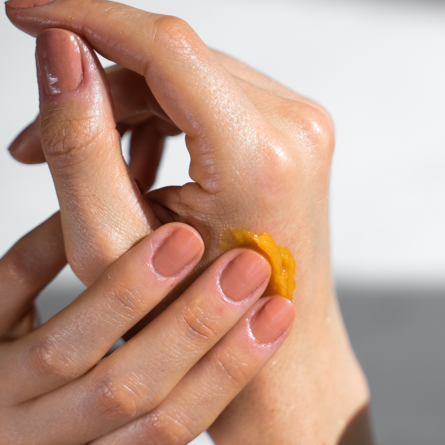 Woman applying Relief Balm to hands